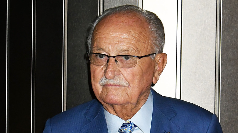 Restaurateur Wolfgang Zwiener, wearing glasses and a blue suit