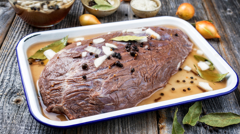 German beef sauerbraten marinating with juniper berries